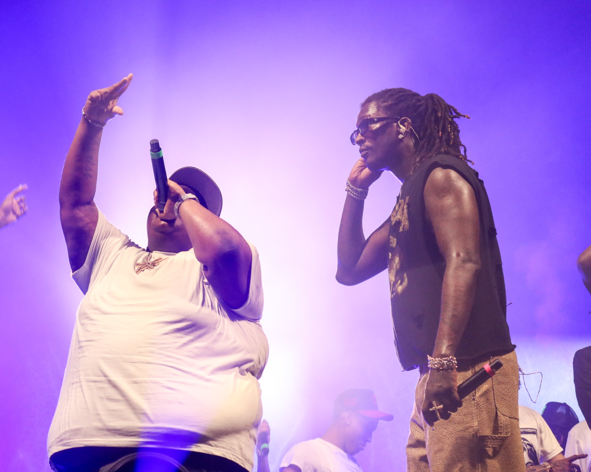 Young Thug performing with another artist under purple stage lights