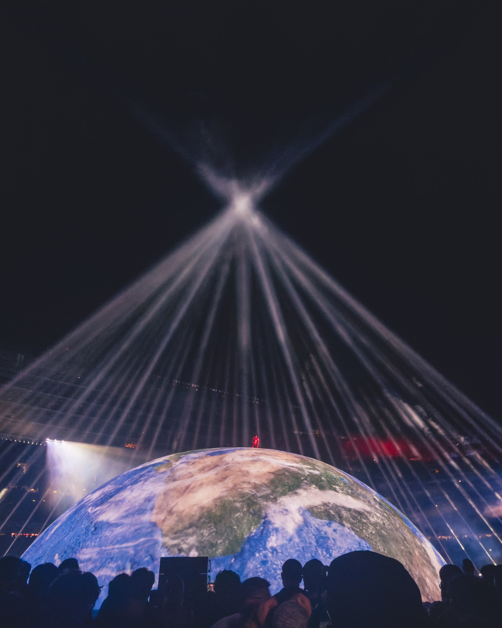 Laser beams converging above the Chicago dome