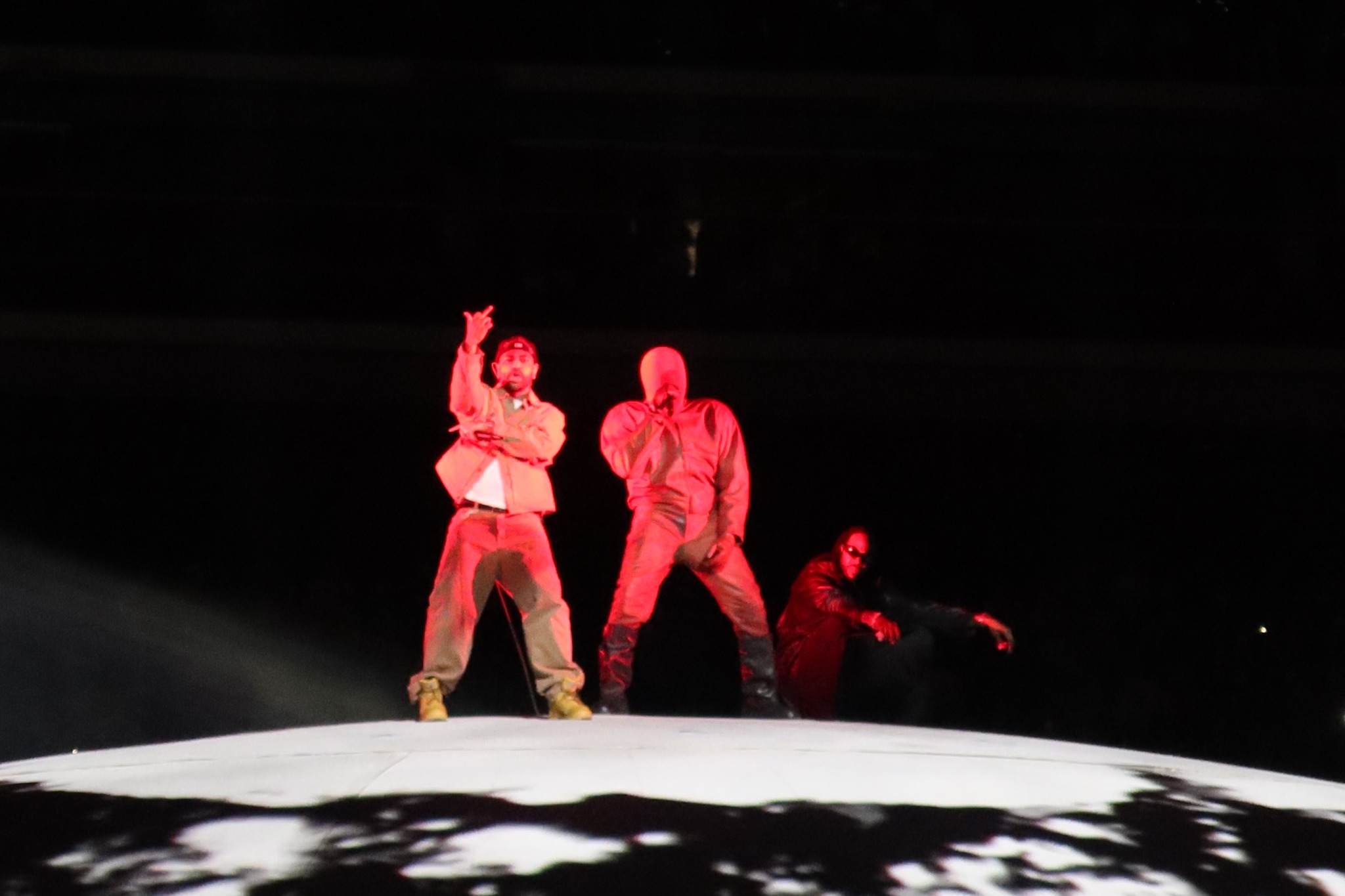 Three performers standing together on the dome