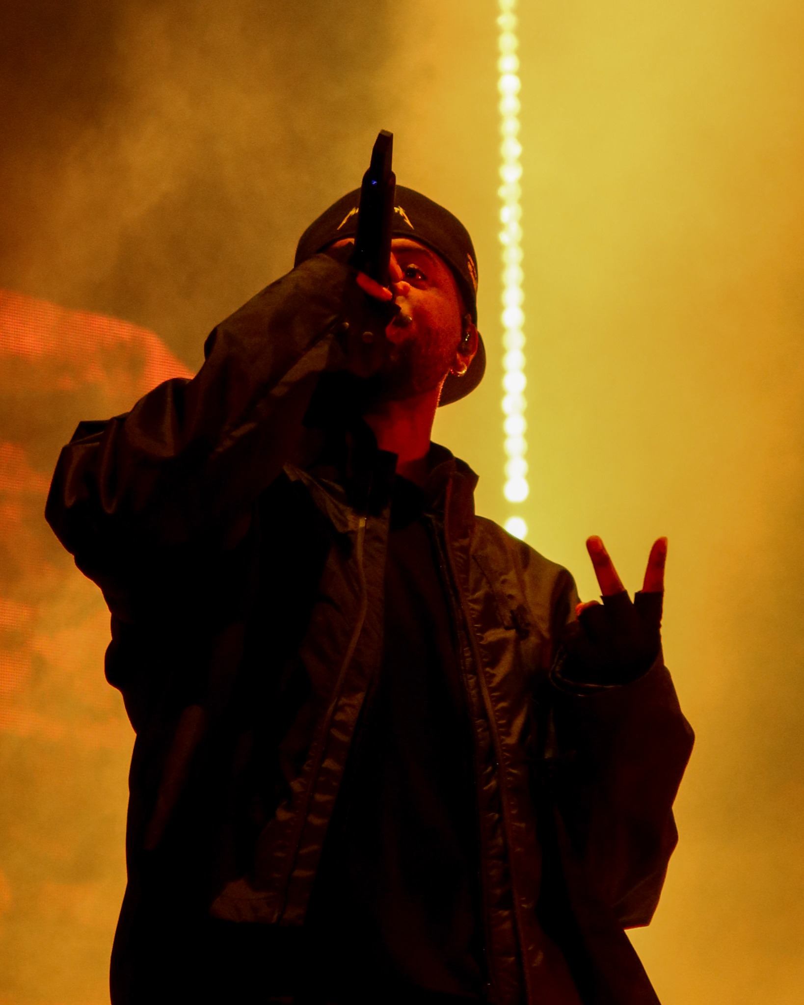 Bryson Tiller performing in warm amber stage light