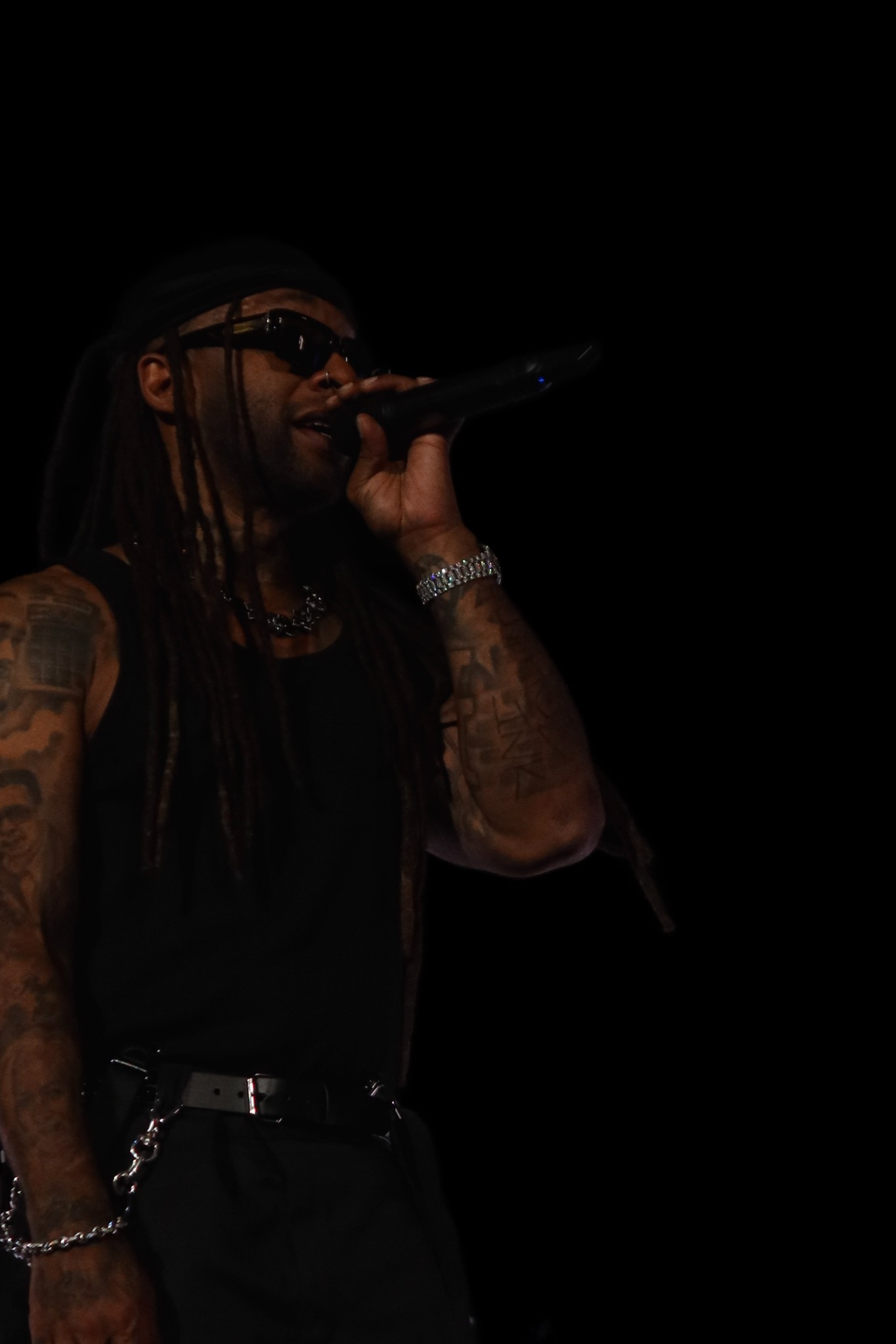 Ty Dolla $ign singing on a dark stage