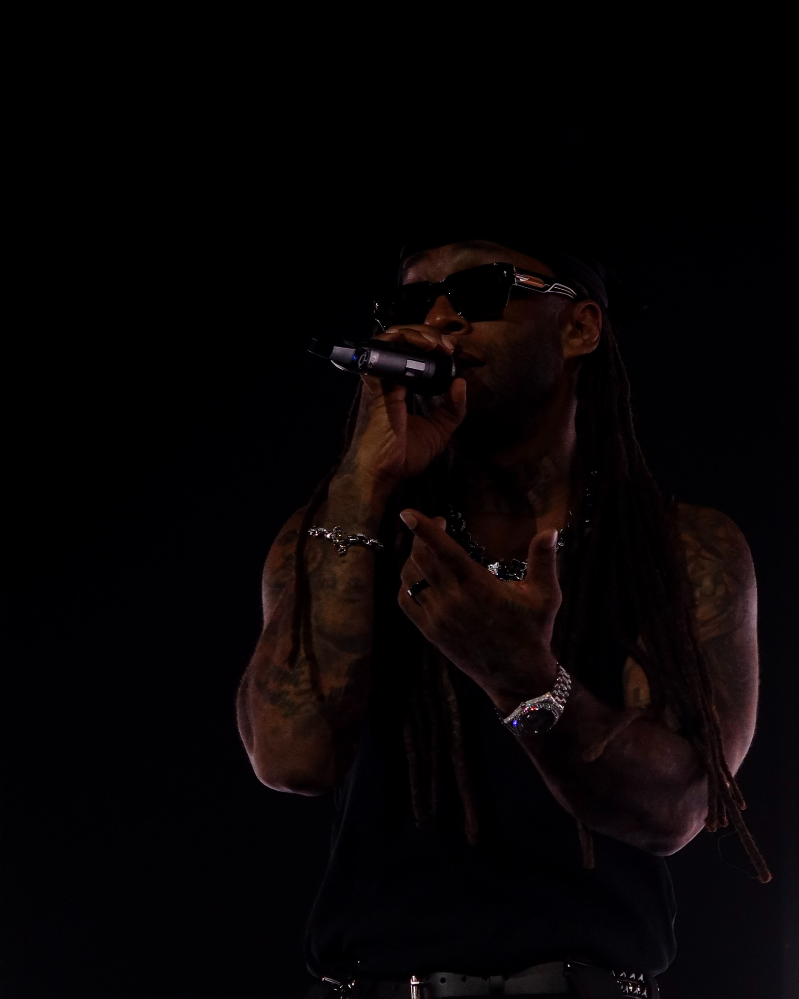 Ty Dolla $ign singing into a handheld microphone