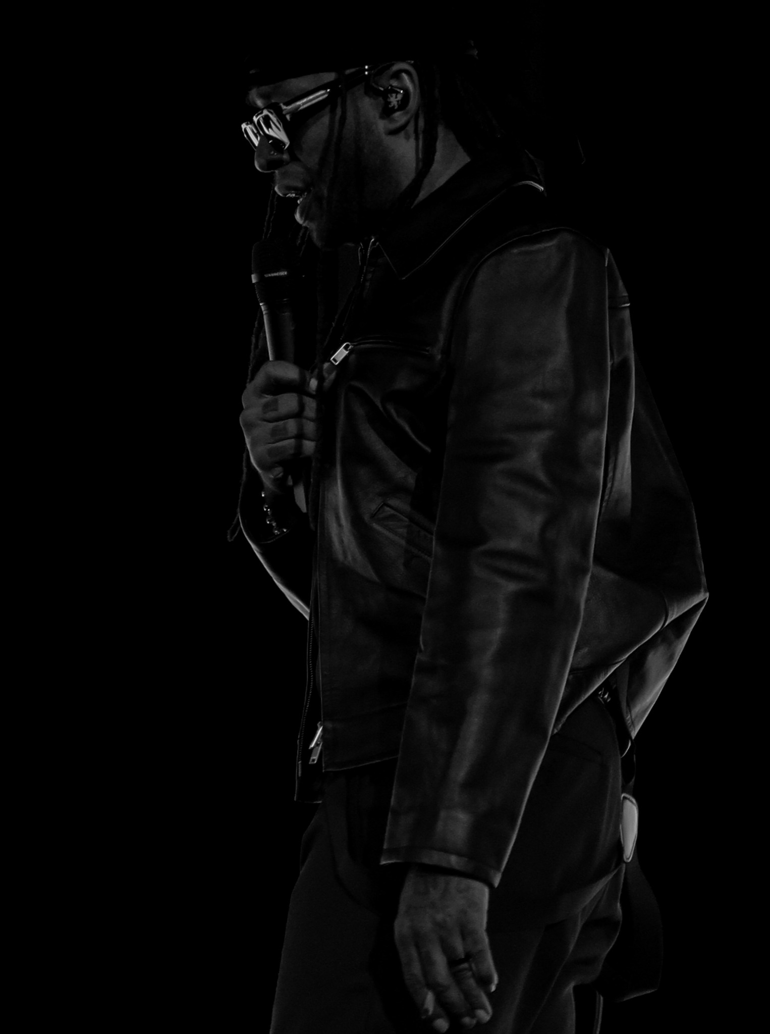 Bryson Tiller in a black-and-white stage portrait