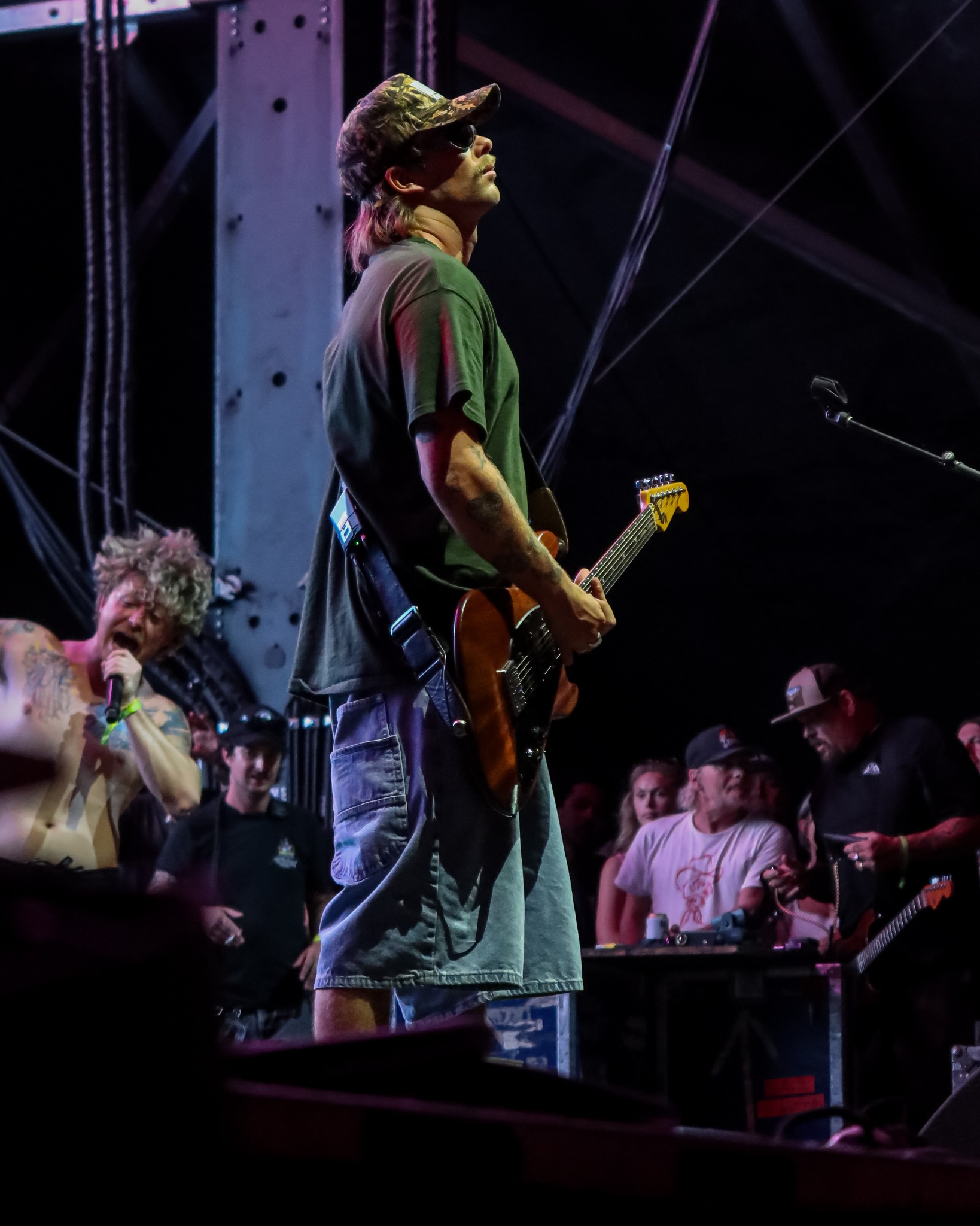 Guitarist performing at the side of the stage