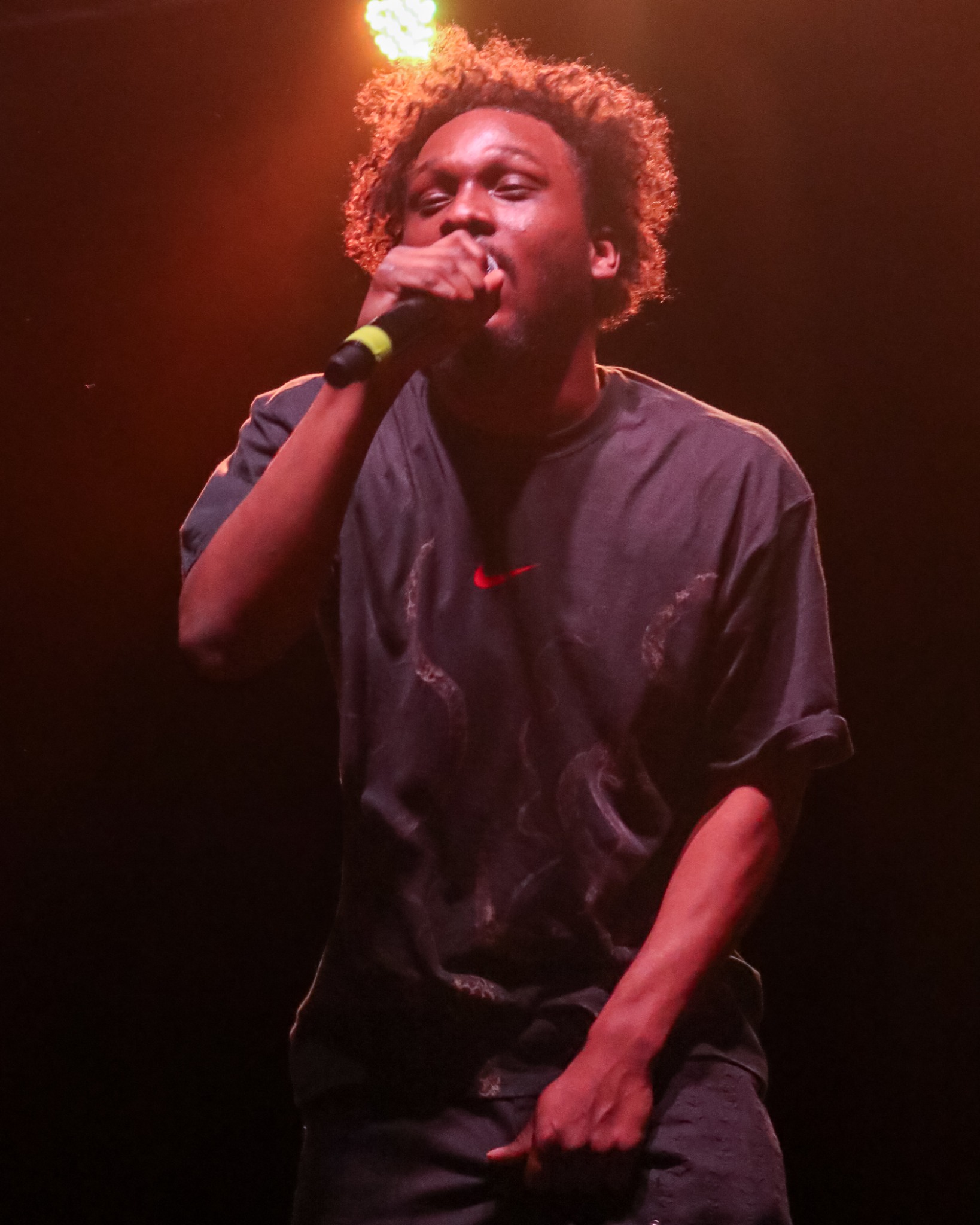 Babyface Ray singing into a handheld microphone
